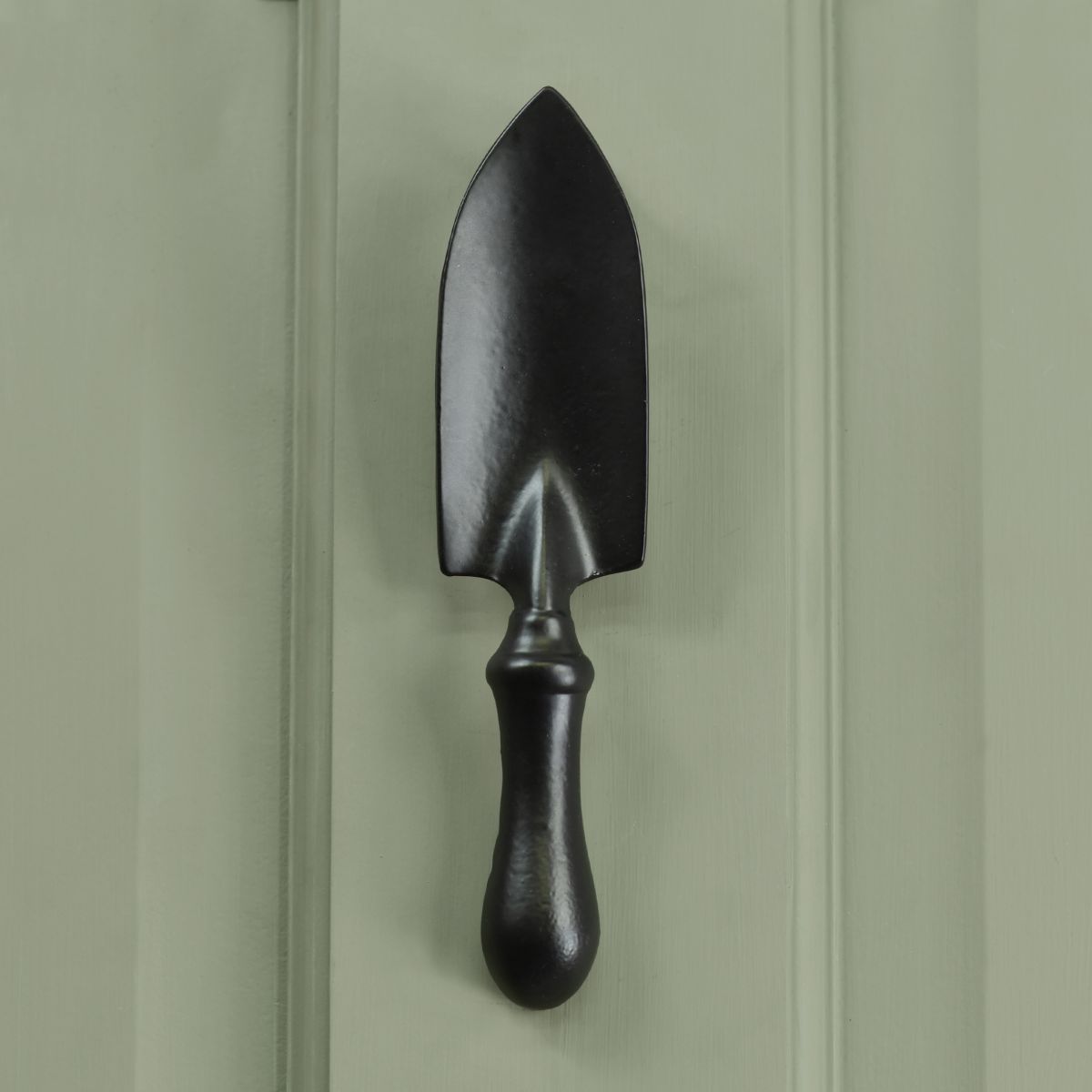 Black Trowel Door Knocker on Green door