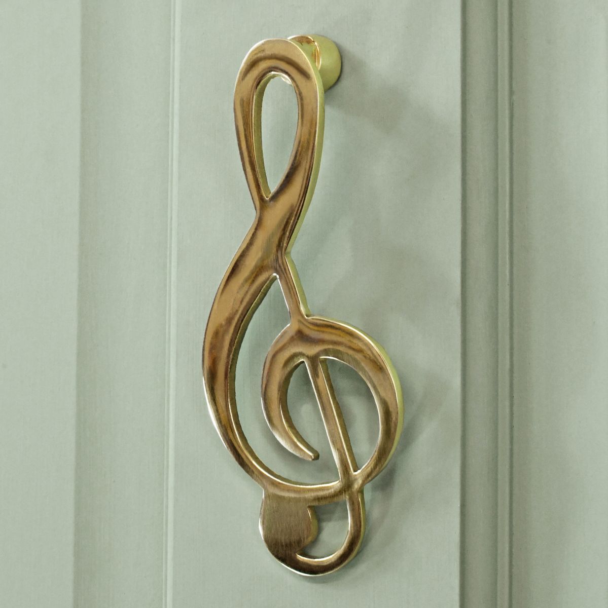 Polished Brass Music Note door knocker on pale green door