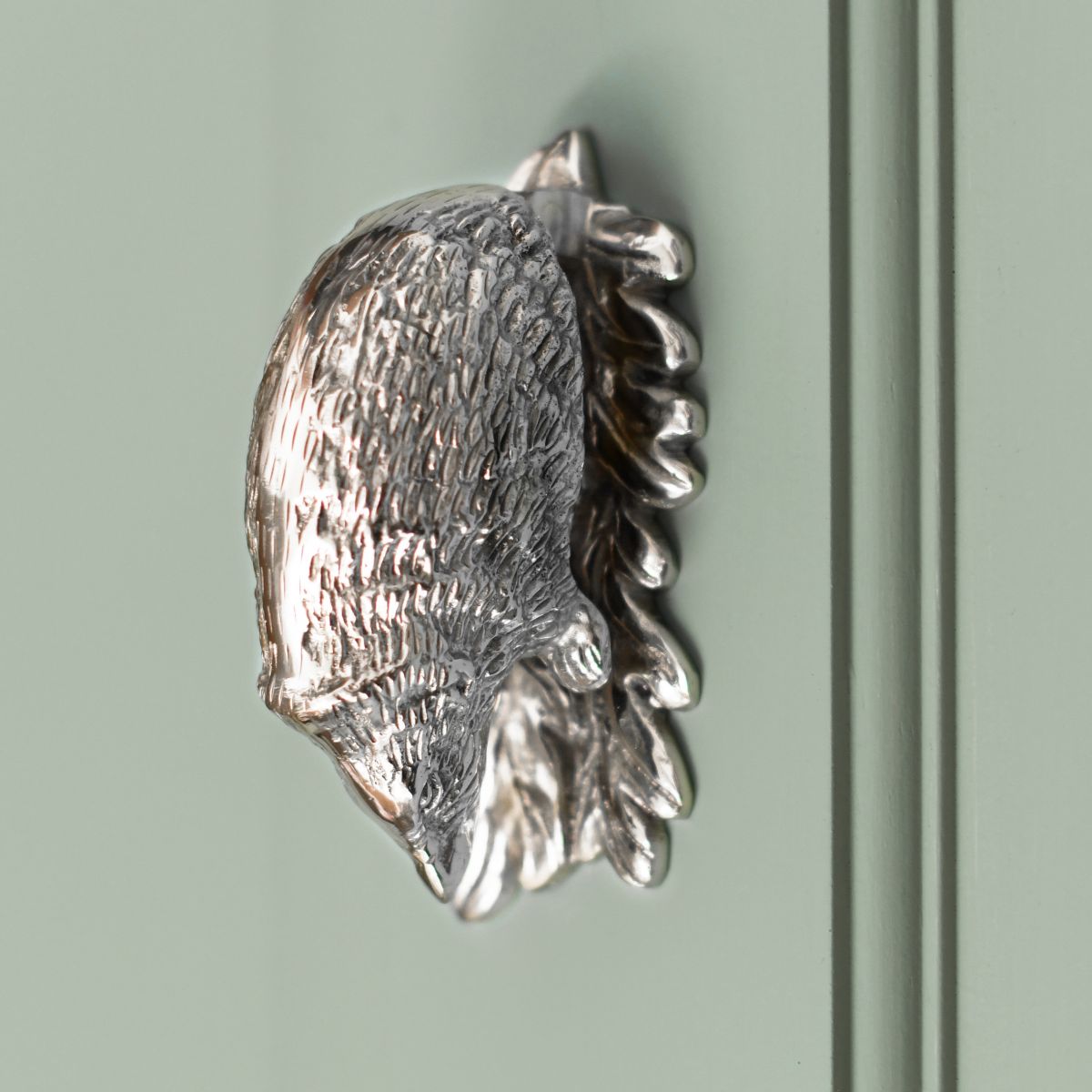 Bright Chrome Hedgehog door knocker on green door