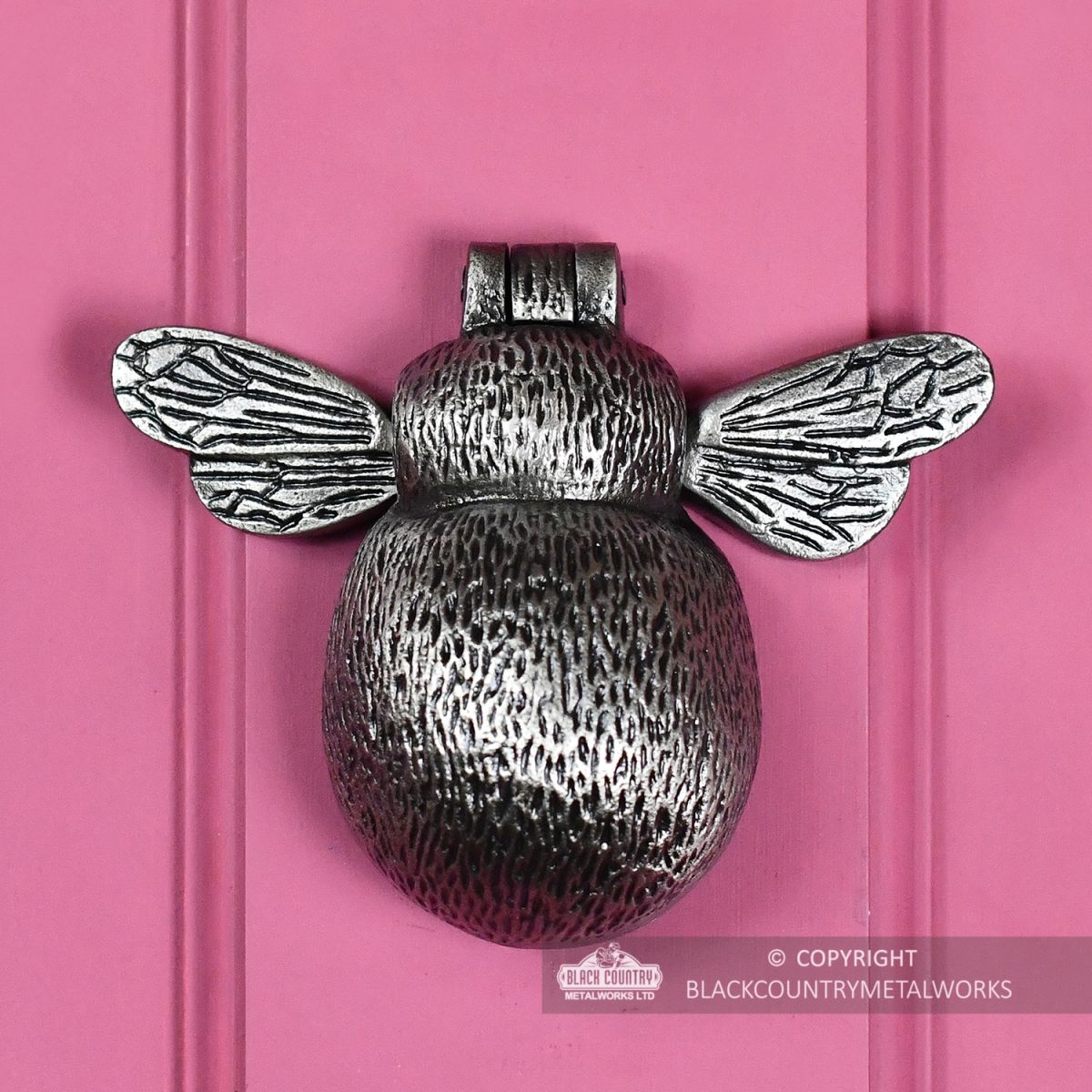 Antique Pewter Bumblebee Door Knocker on a Pink Door