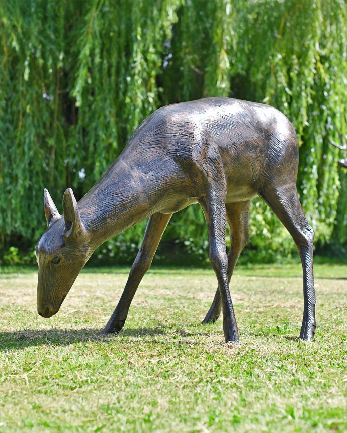 Doe Sculpture Head Down Eating in Situ in the Garden