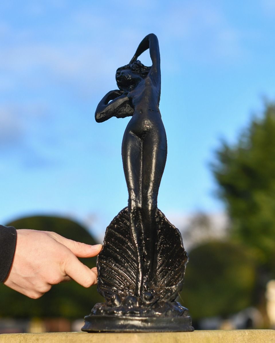 Black Statue Of A Lady In. A Clam In Situ 