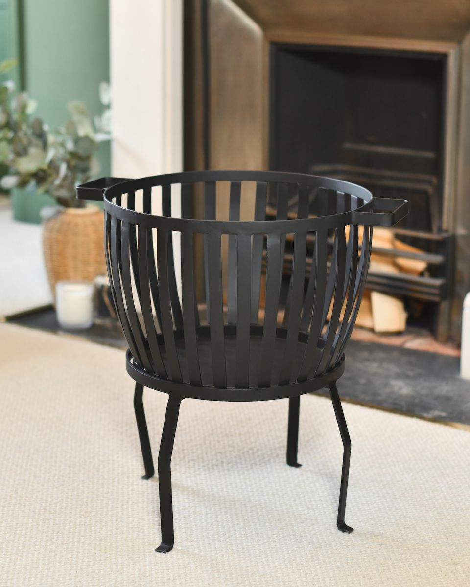 Traditional black fireplace log storage