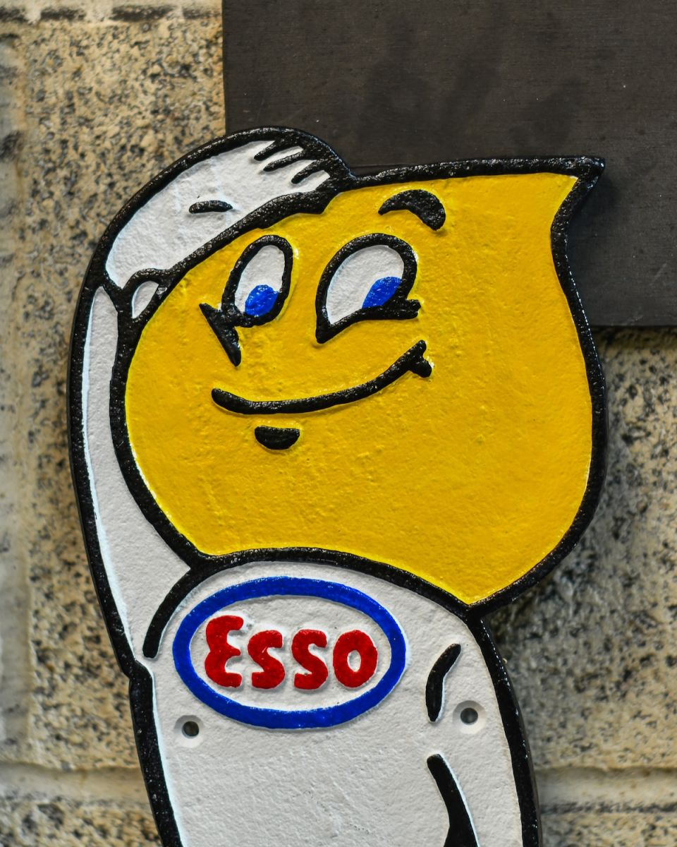 Close up of hand painted cast iron wall sign