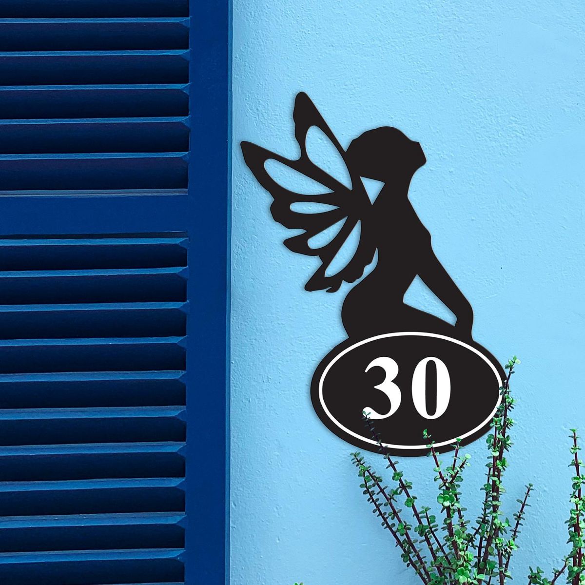 Fairy Iron House Number Sign in Situ on a Blue Wall  Fairy Iron House Number Sign in Situ on a Blue Wall