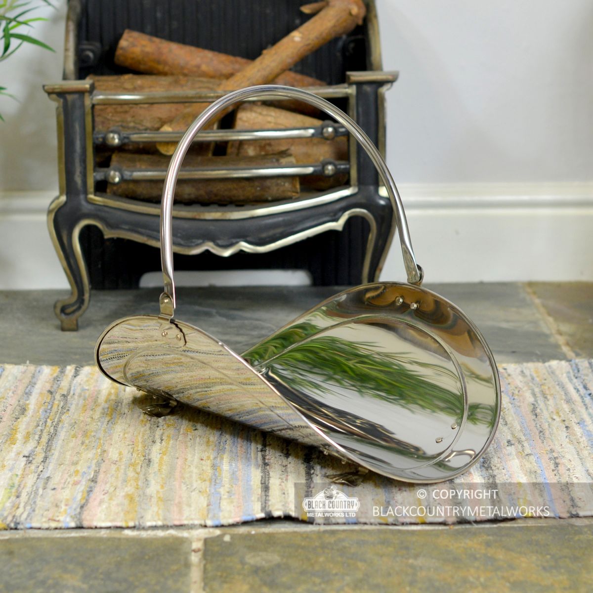 "Evington" Stainless Steel Curved Log Basket by a Wood Fire