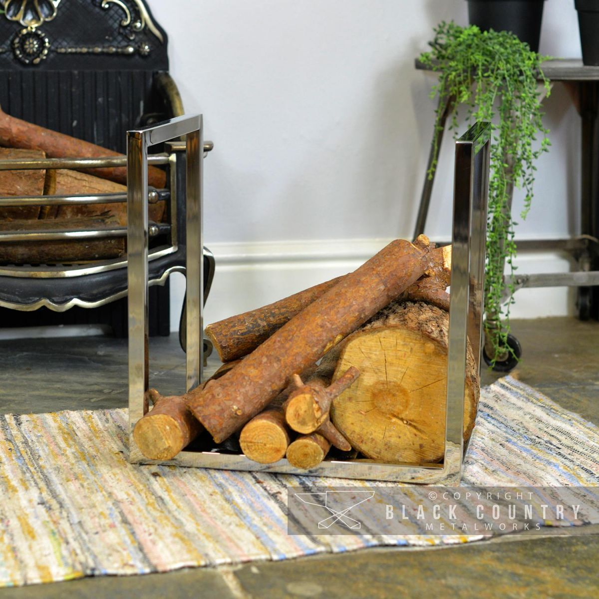 Square Stainless Steel Log Holder Holding Logs in Front of the Fire