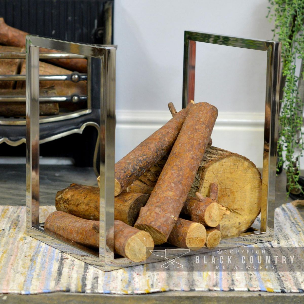 "Kresling Hall" Stainless Steel Log Holder in Situ holding Logs