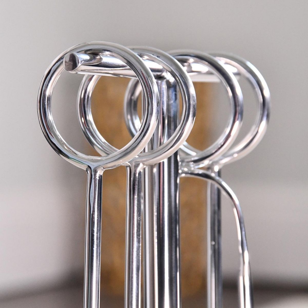Close up of circular handles on polished steel companion set 