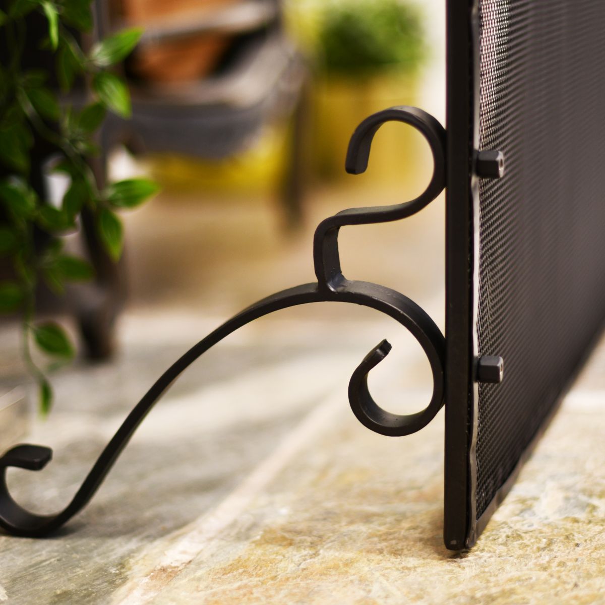 Wrought iron leg on fireguard