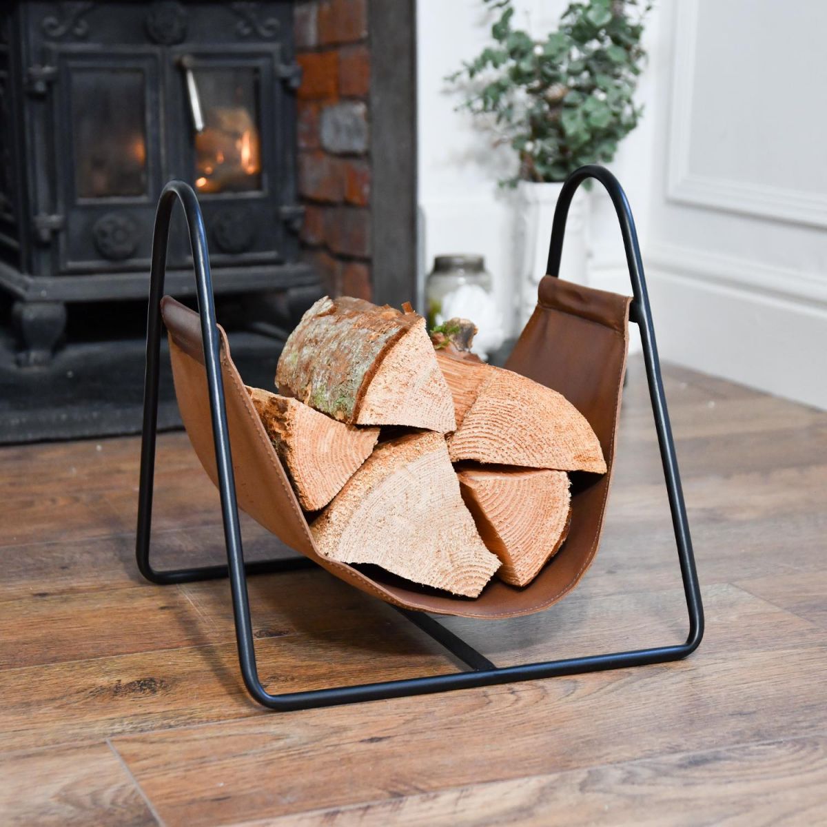 Black Steel & Brown Leather Log Holder on Wooden Floor