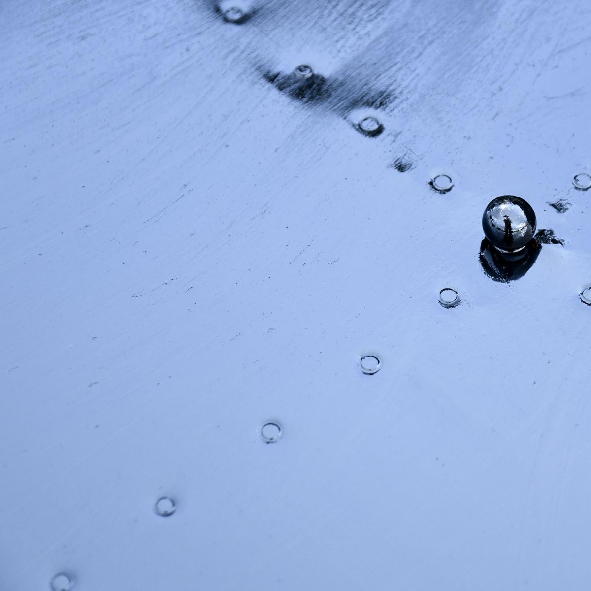 Close up of circular lid with decorative detailing and ball handle 