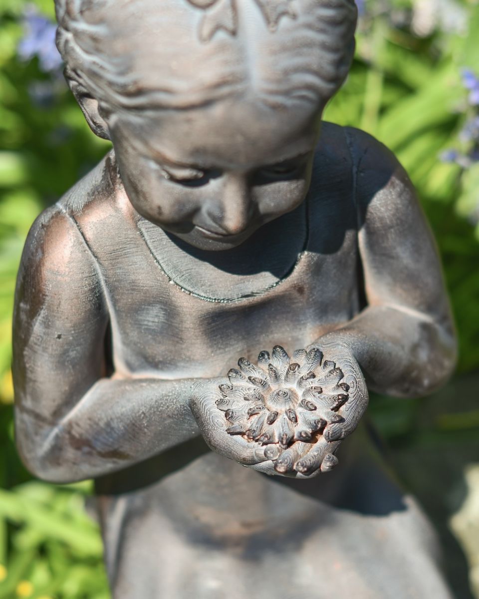 Close up of intricate flower detail on garden statue