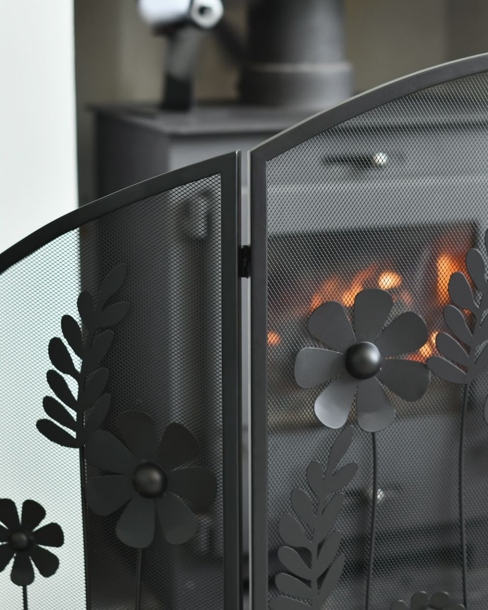 Close up of curved border detail on black decorative fire screen Close up of curved border detail on black decorative fire screen