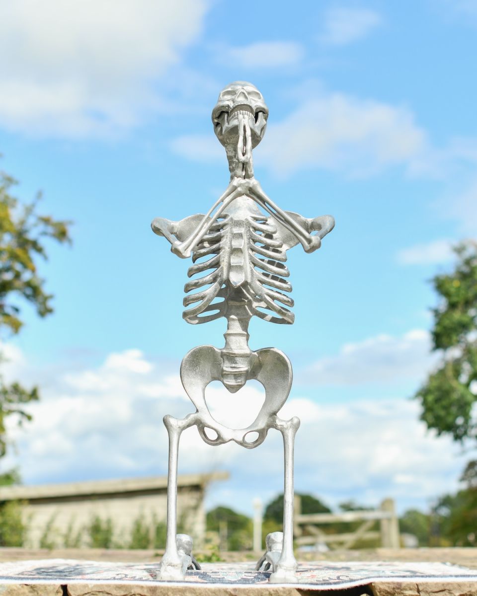 Front view of silver skeleton garden sculpture