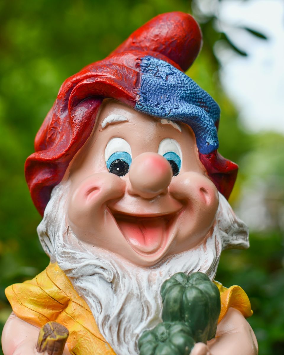 Close up of intricate face detail on colourful garden gnomes