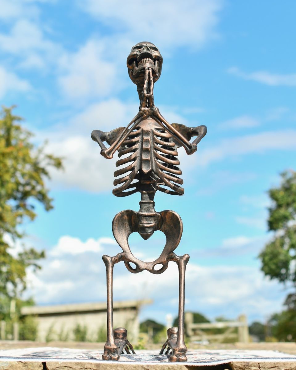 Frint view of copper skeleton garden sculpure