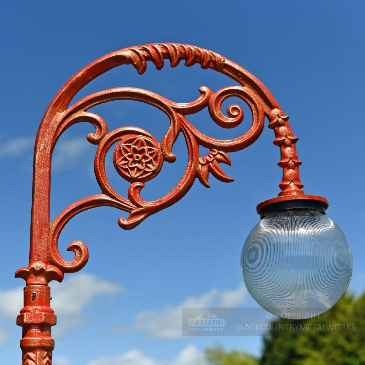 Frosted Glass Globe Luminaire On ornate lamp post bracket