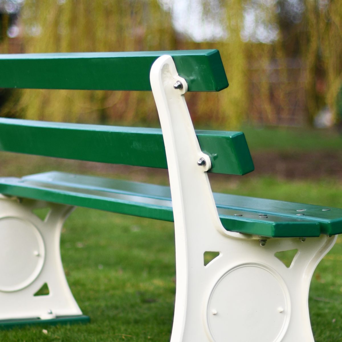 Close up image of back of bench - cream disk & wooden slats Close up image of back of bench - cream disk & wooden slats