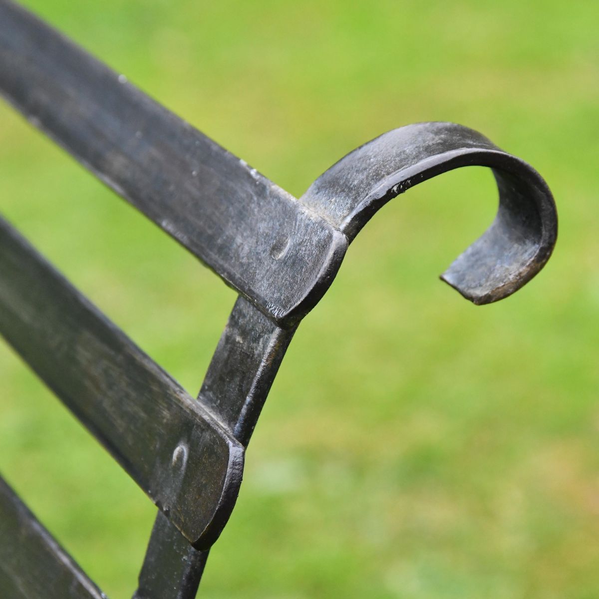 Black Two Seater Park Bench Curved Backrest Close-Up Black Two Seater Park Bench Curved Backrest Close-Up