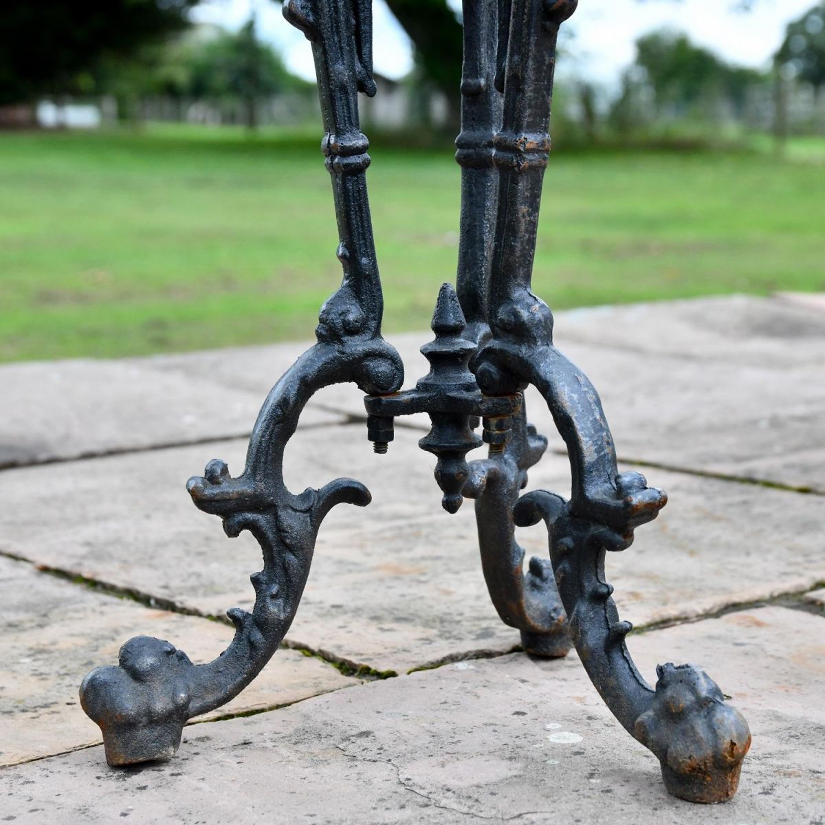 Close up of Aged Black Cast Iron Side Table Legs 