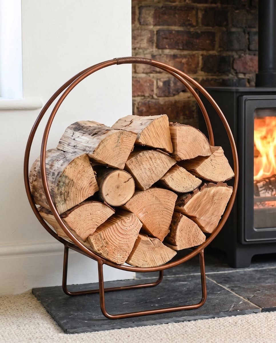 The 69.5cm Copper Contemporary Circular Log Rack & Holder in a Modern Living Room next to a Log Burner - Digital Illustration  