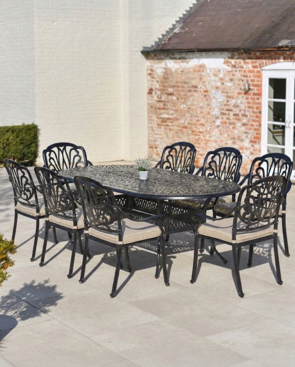 aged_black_moreville_eight_seater_furniture_set_in_situ_outside_on_a_patio with cushions