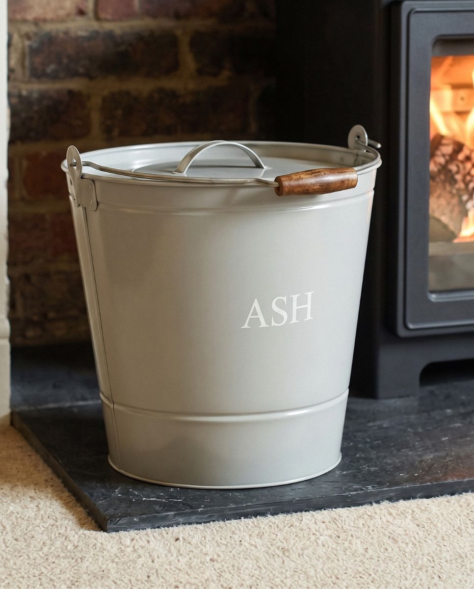 The Grey Ash Bucket with Lid next to a Lit Log Burner Stove in a Modern Home Interior - Digital Illustration