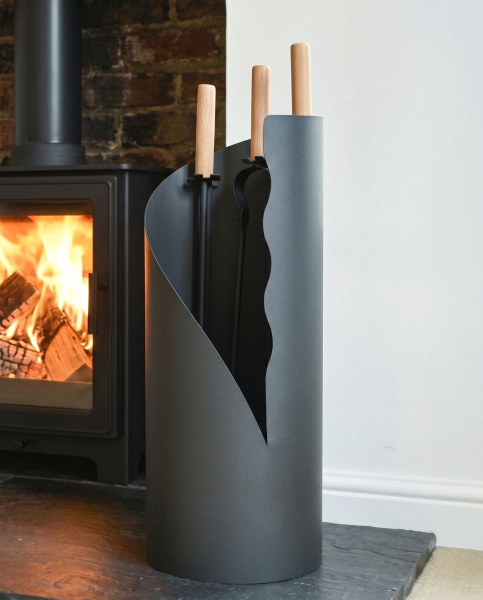The Grey Contemporary "Waves" Companion Set next to a Traditional Log Burner Stove - Digital Illustration 