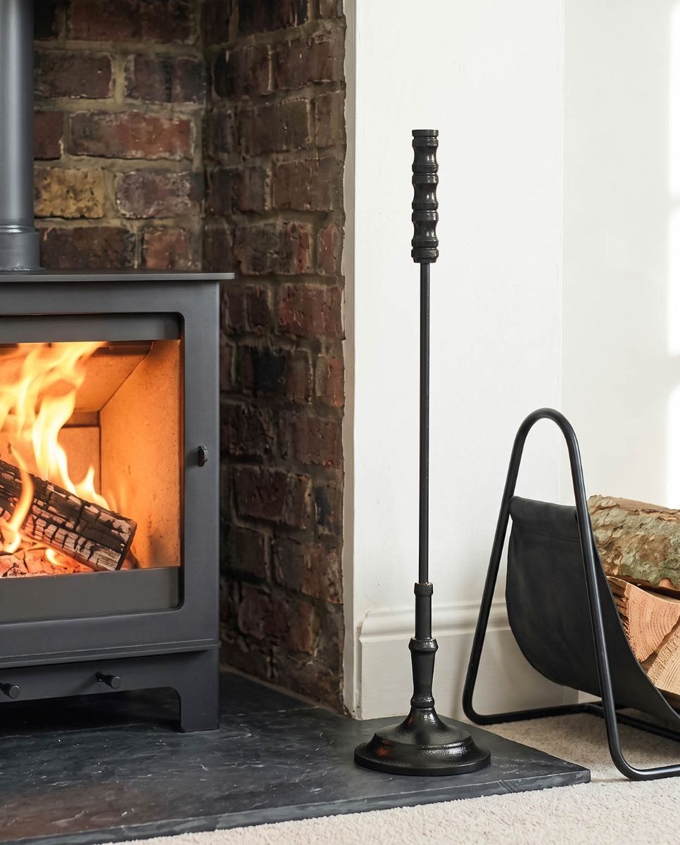 The Calibre Fireside Poker on a Decorative Fireplace next to a Lit Log Burner - Digital Illustration 