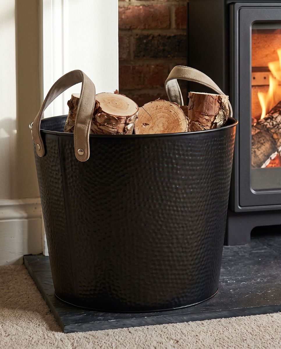 The Large Black Contemporary Dotted Log Basket on a Black Stone Hearth by a Log Burner Stove - Digital Illustration 