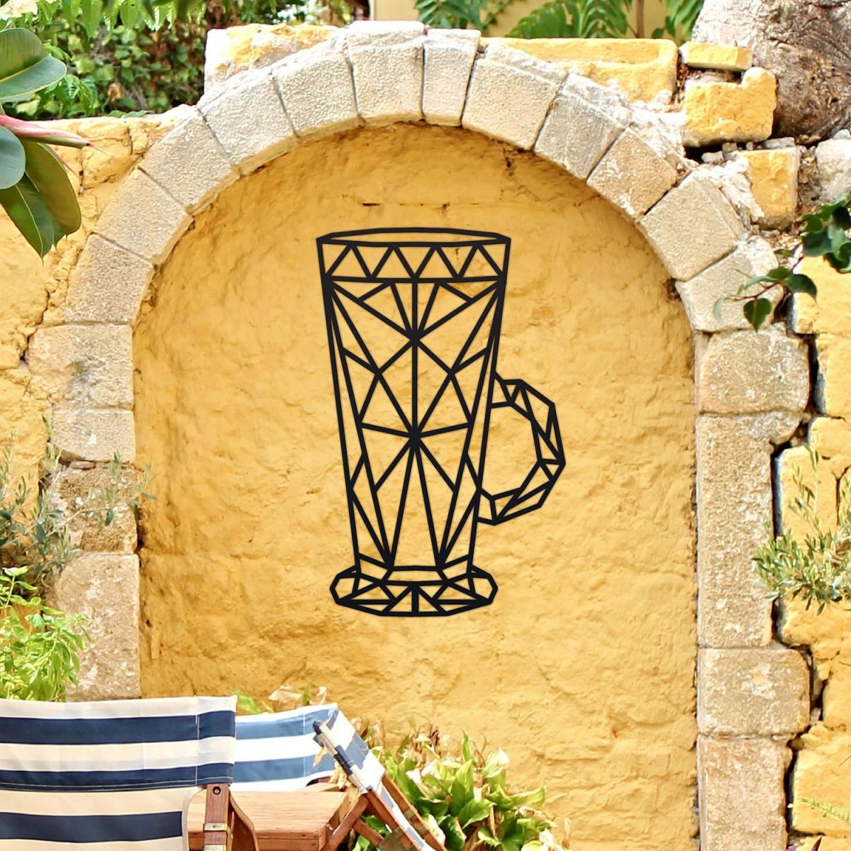 Geometric Steel Latte Glass Wall Art on a Yellow Garden Wall