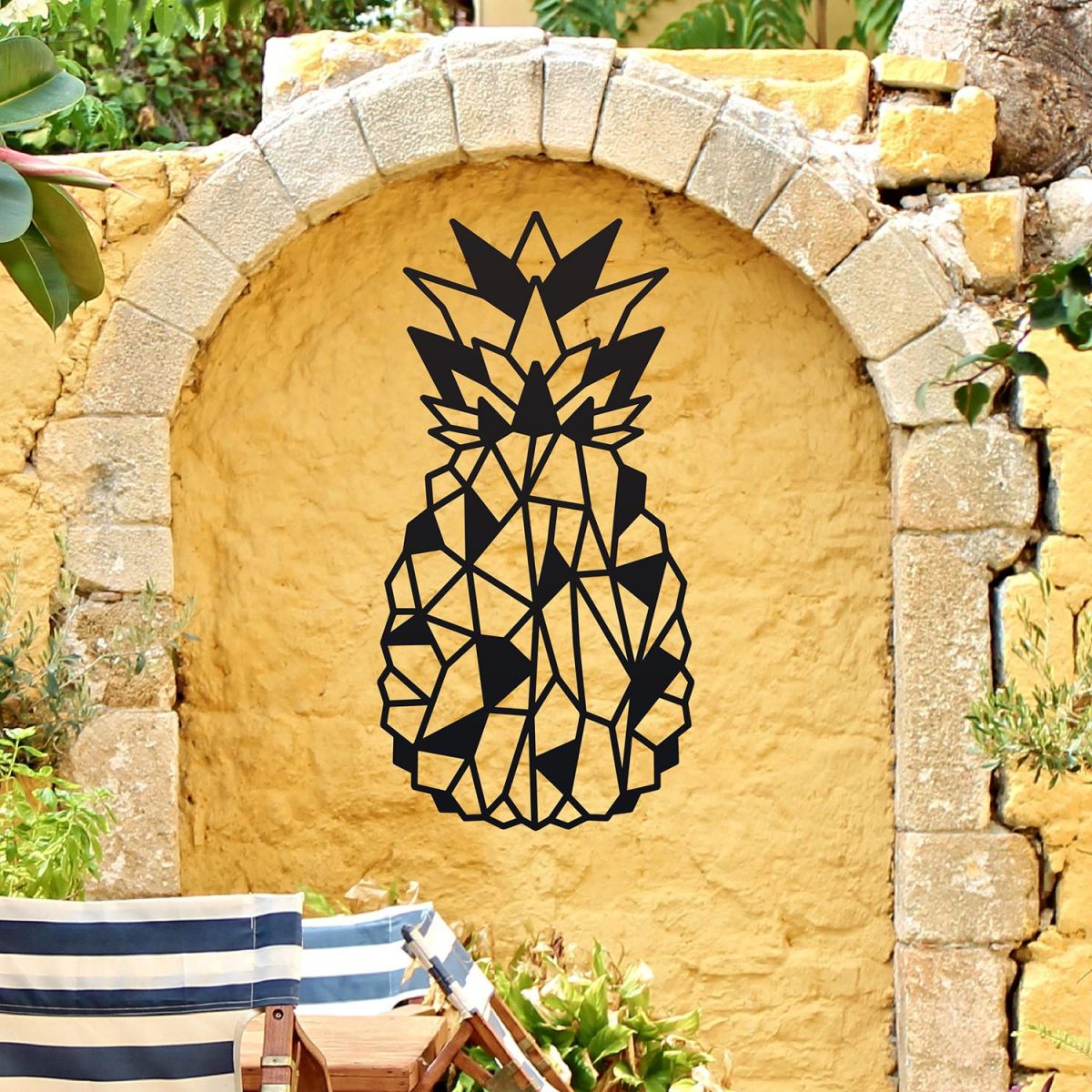 Geometric Steel Pineapple Wall Art in Situ on a Yellow Garden Wall