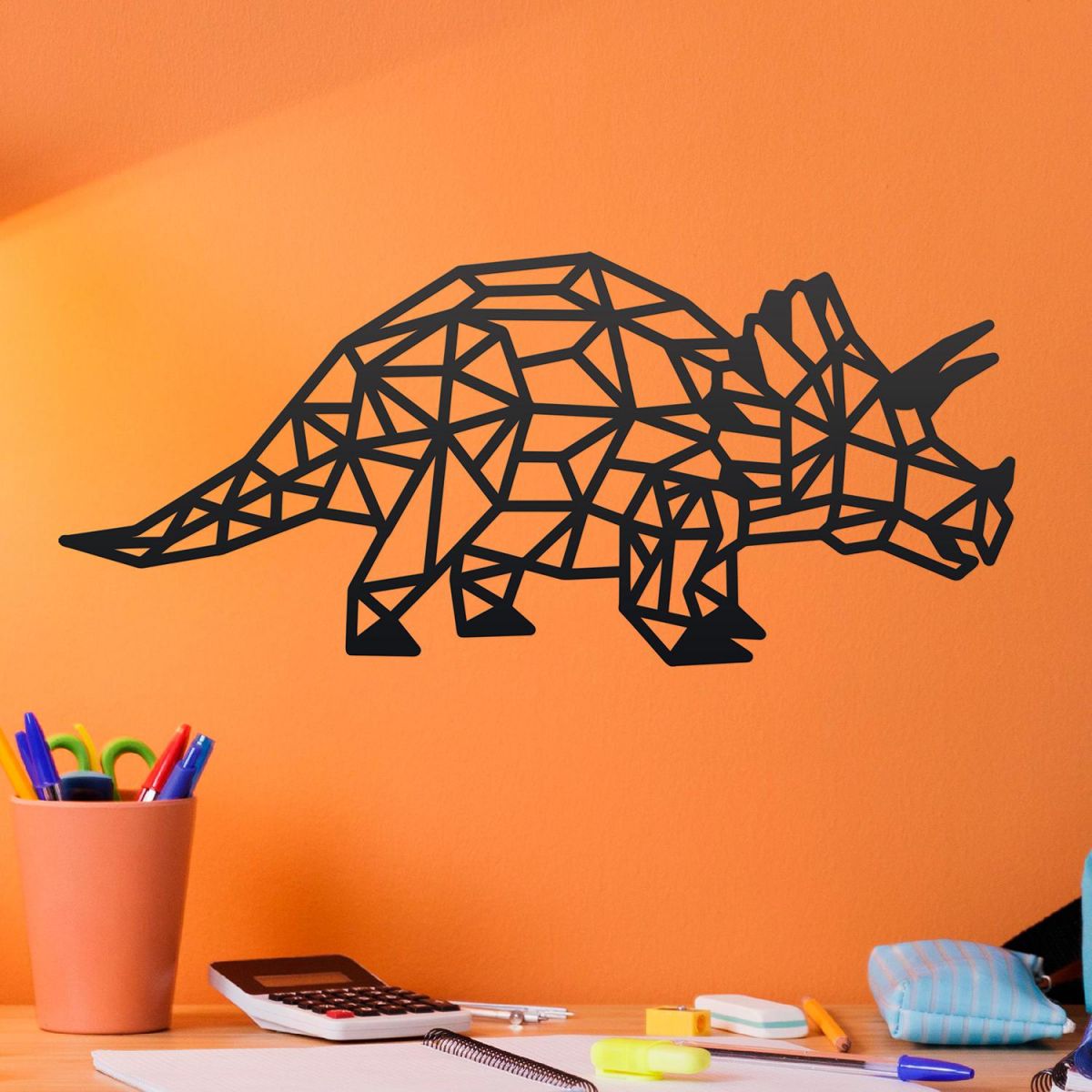 Geometric Iron Triceratops Wall Art on an Orange Wall