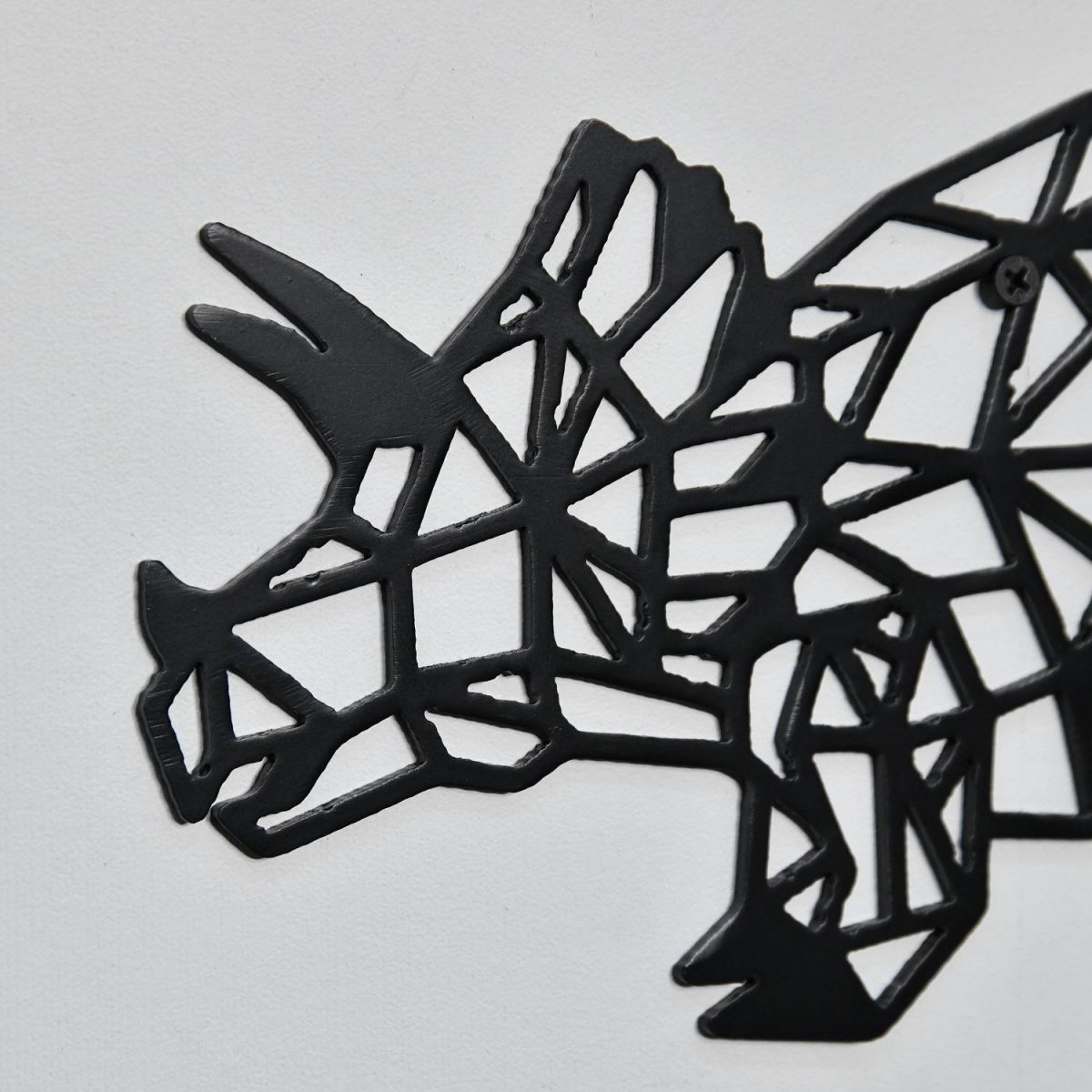 Close up of black powder coated steel triceratops