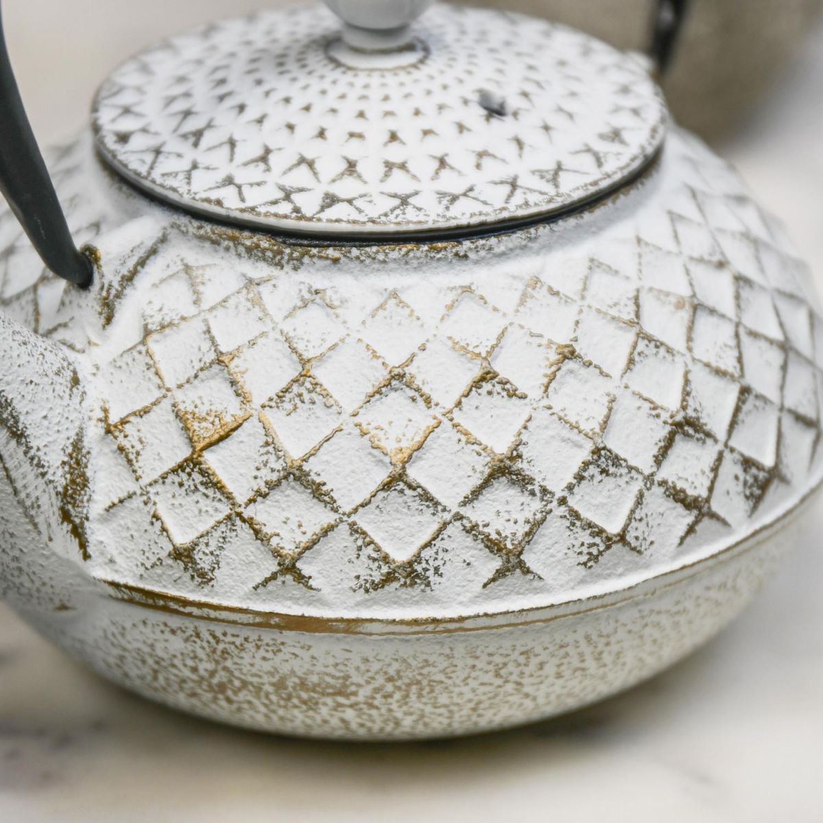 Close Up Of Gold & White Cast Iron Teapot Finish Close Up Of Gold & White Cast Iron Teapot Finish