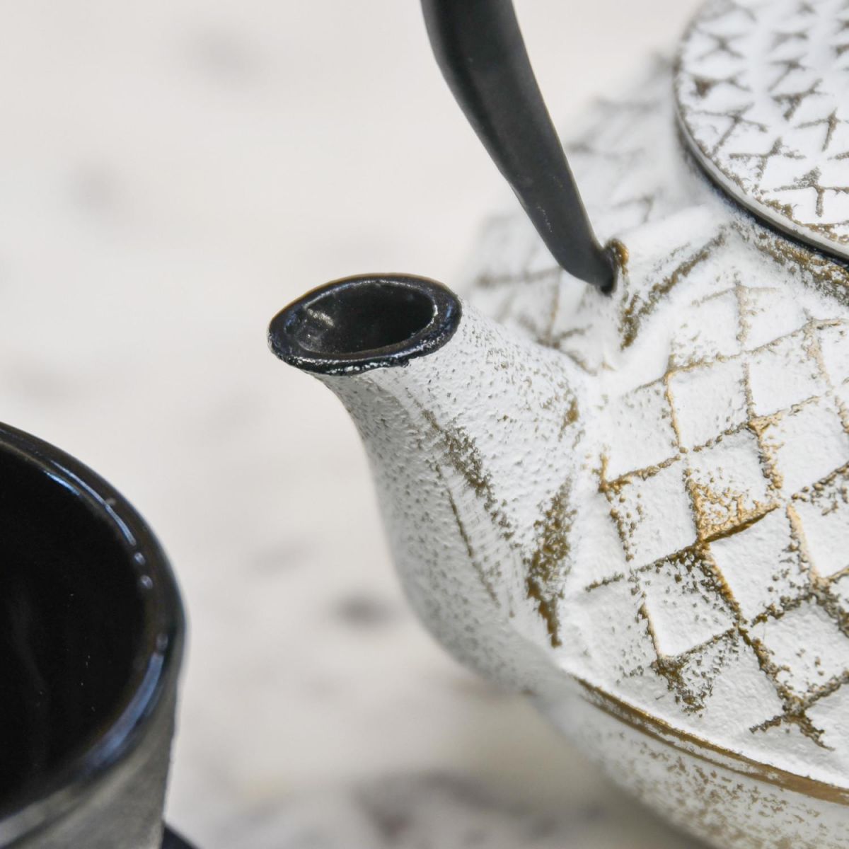Close Up Of Gold & White Cast Iron Teapot Spout Close Up Of Gold & White Cast Iron Teapot Spout