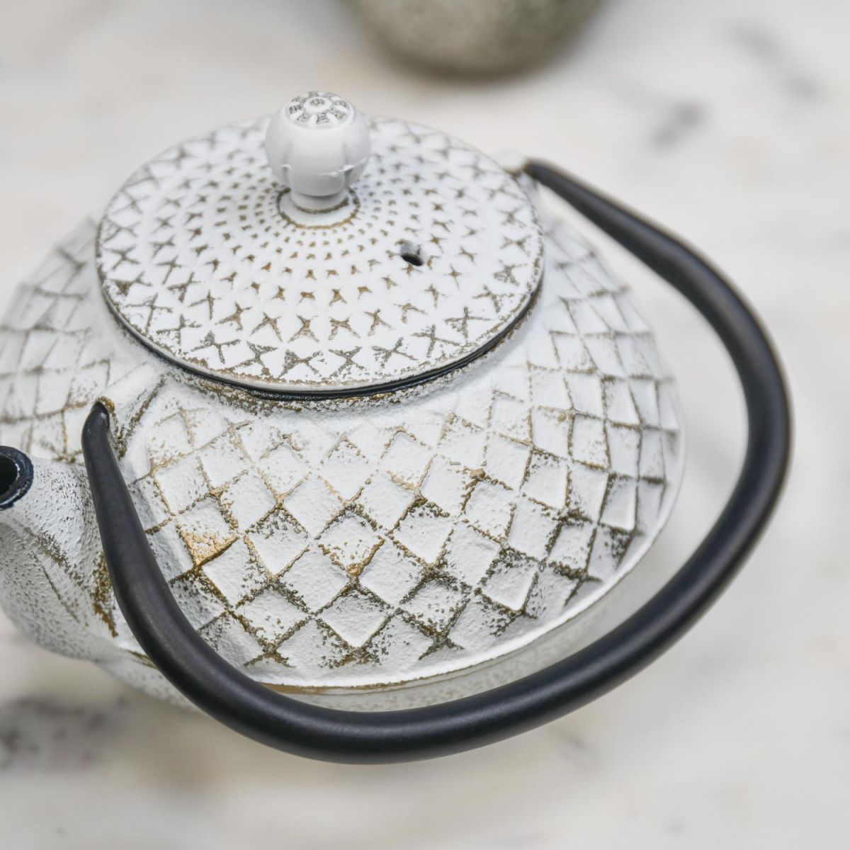 Close Up Of Gold & White Cast Iron Teapot Top Close Up Of Gold & White Cast Iron Teapot Top