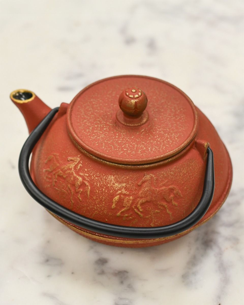 Top of Cast Iron Teapot with Lid on and Black Handle 
