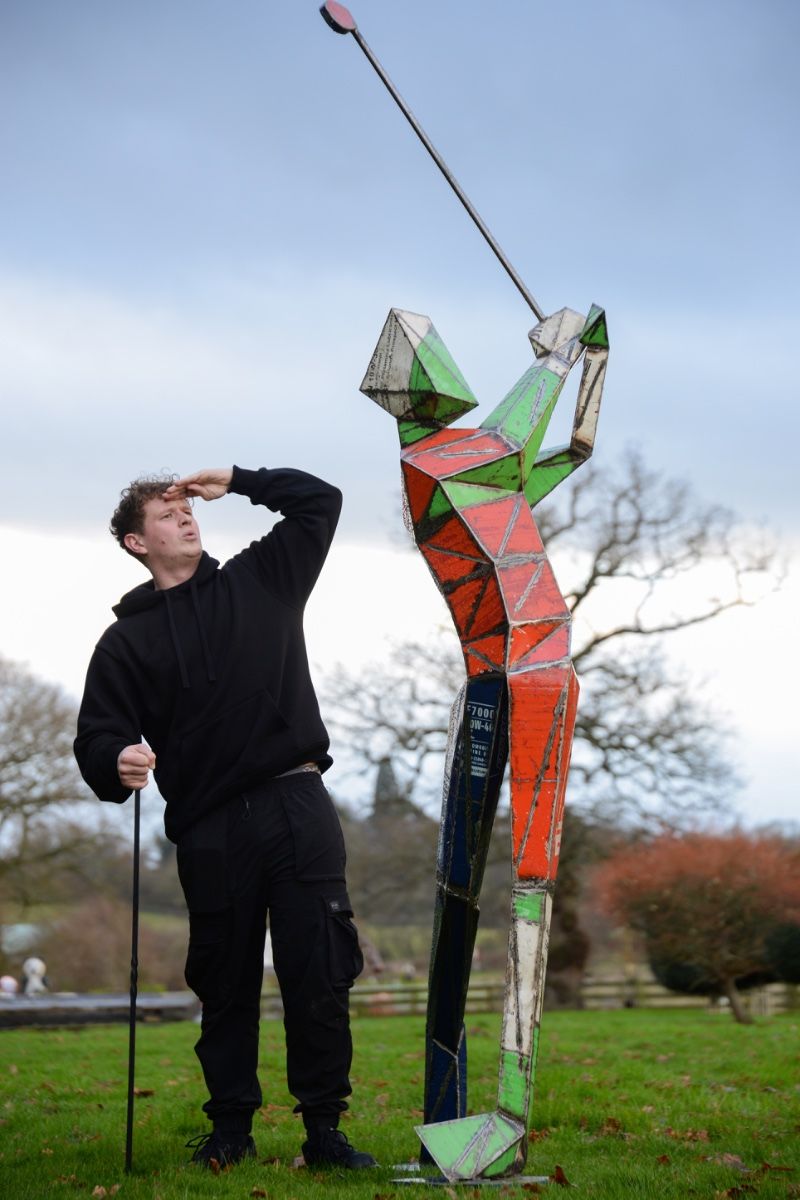 ‘Birdie’ the Golfing Upcycled Oil Drum Garden Sculpture with man stood next to it looking into distance
