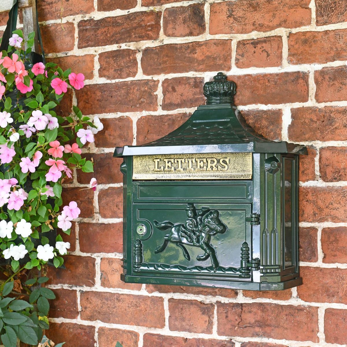 Green "Odell" Wall Mounted Post Box in situ on the Front of a House