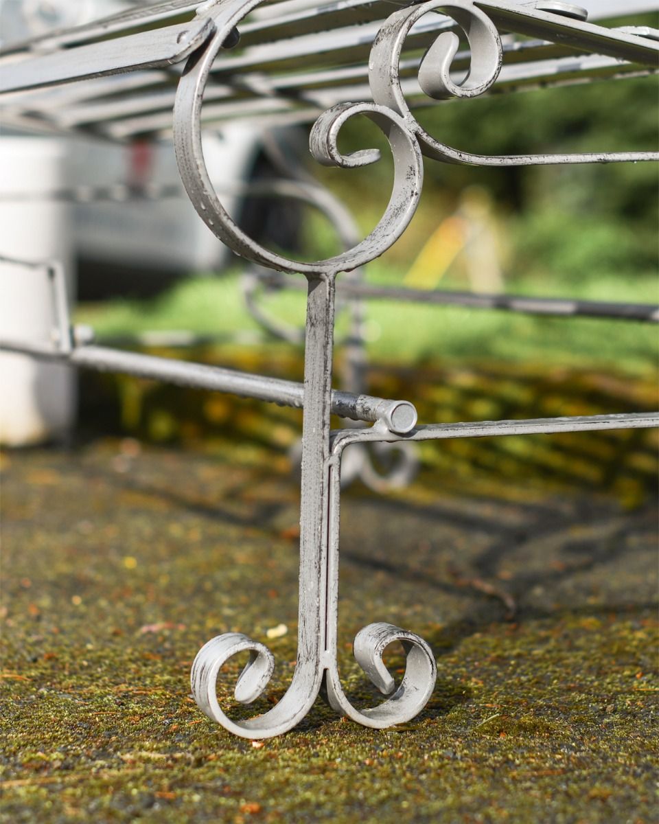 Close up of curved legs on rustic bench 