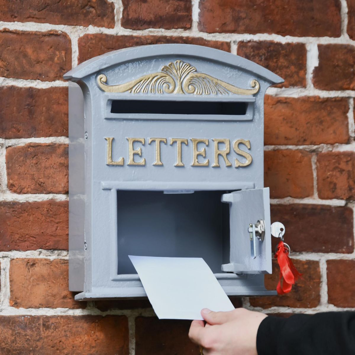 Letter Opening in Use on Grey & Gold Curved Cambridge Traditional Wall Mounted Post Box