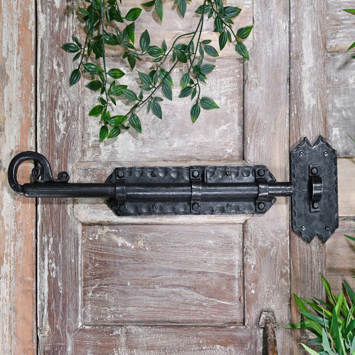 Grimoire Door Bolt in Situ on a rustic Wooden Door