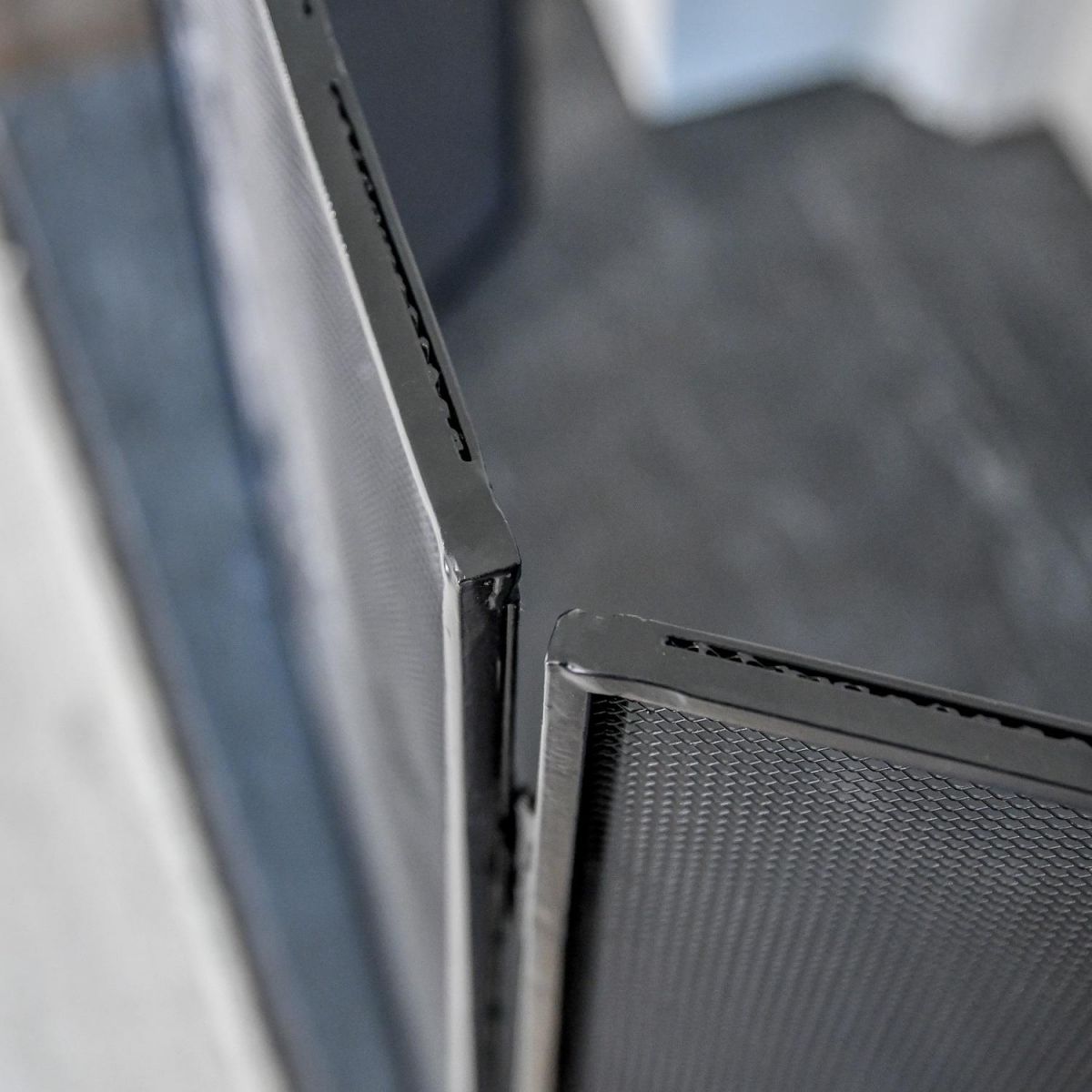 Birdseye view of mesh netting and framework on three fold fire guard Birdseye view of mesh netting and framework on three fold fire guard