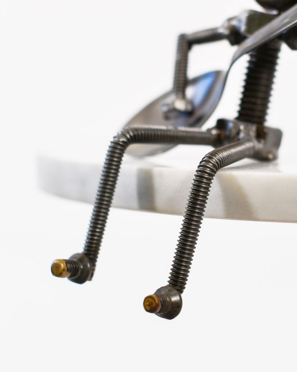 Close up of legs and feet detail on scrap metal art sculpture Close up of legs and feet detail on scrap metal art sculpture