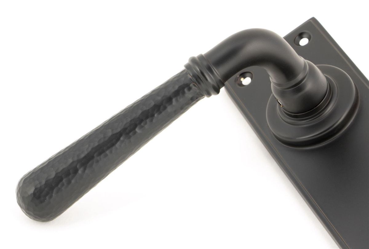 Hammered Aged Bronze Lever Bathroom Door Handle Close-Up Hammered Aged Bronze Lever Bathroom Door Handle Close-Up