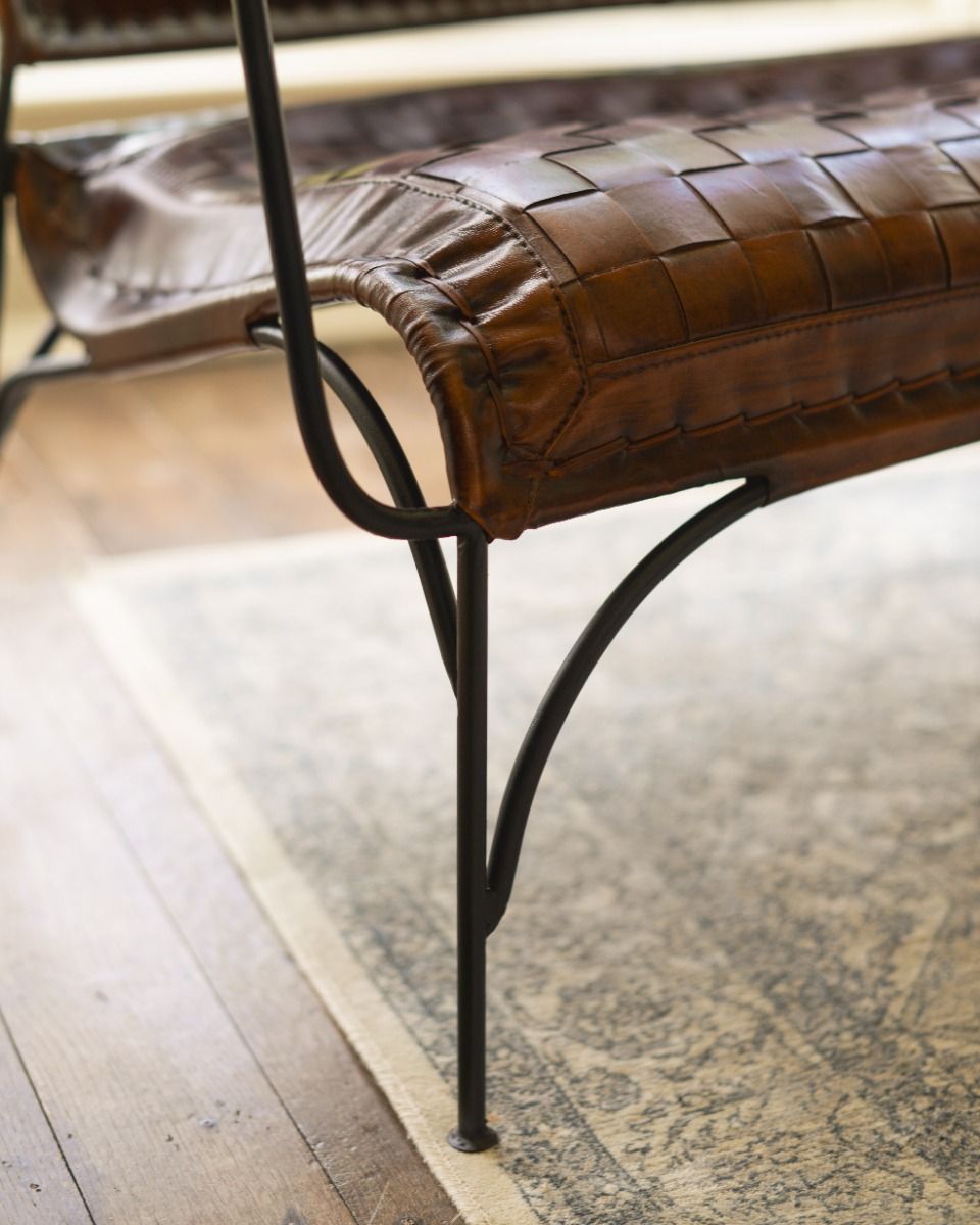 Hand Woven Tan Leather and Iron Two Seater Chair Legs Close Up