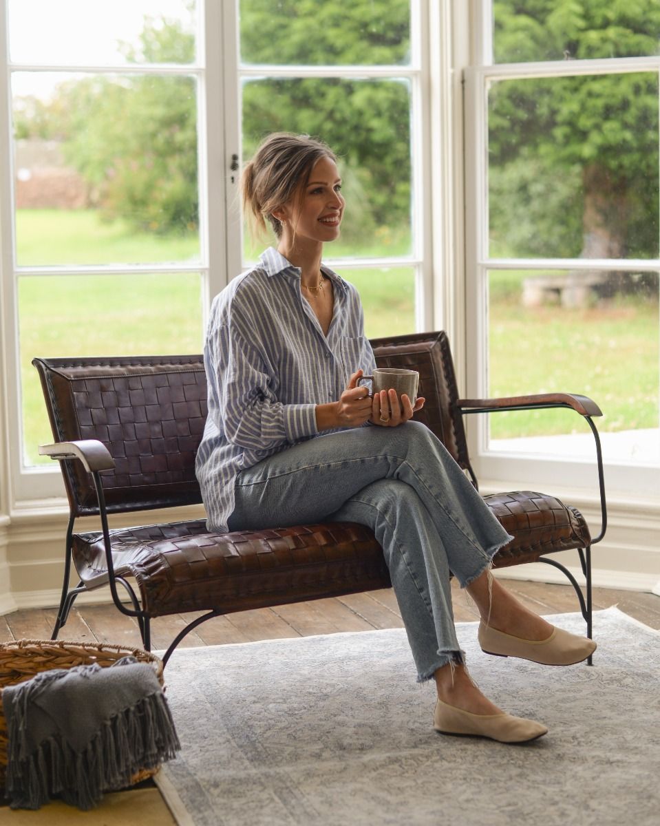 Hand Woven Tan Leather and Iron Two Seater Chair with Person Sat for Scale