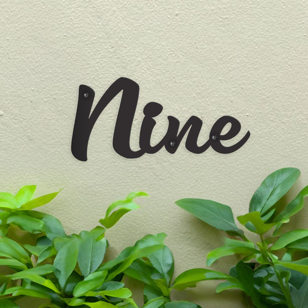 Black Handwritten House Number Sign on green wall